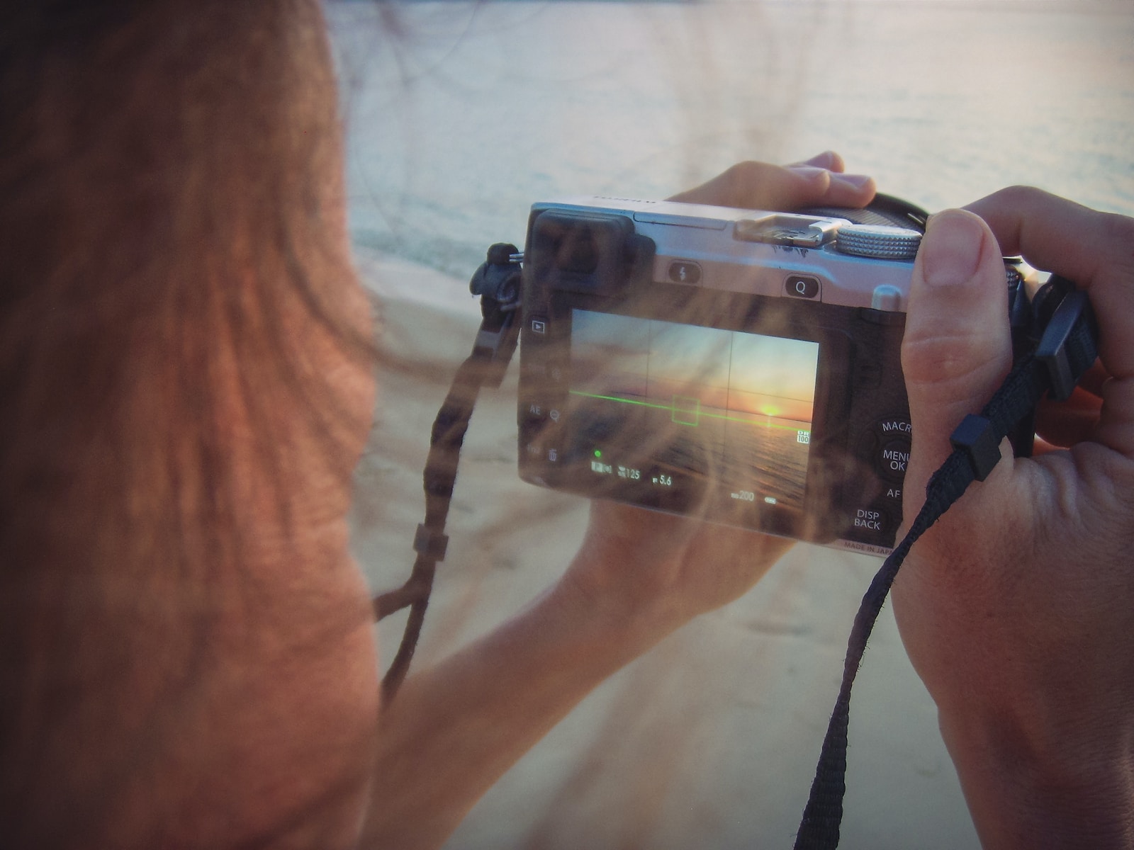 person holding black dslr camera